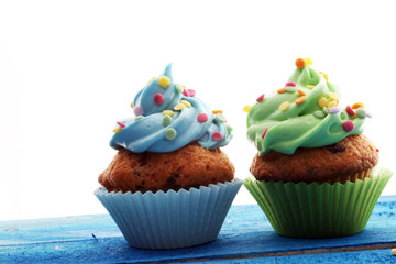 Tasty cupcakes on wooden background. Birthday cupcake in rainbow colors