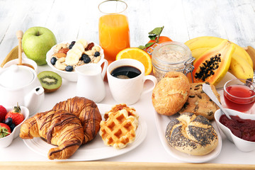 Breakfast served with coffee, orange juice, croissants and fruits. Balanced diet.