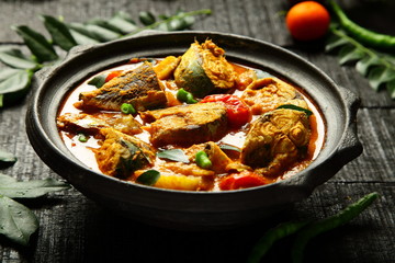 Healthy seafood curry cooked in coconut milk and mango slices.