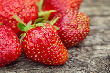 Fresh strawberry on a wooden aged background