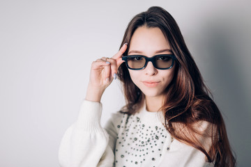 Young beautiful woman with 3d glasses with a smile looking at the camera