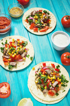 Mexican pork tacos with vegetables. Tacos al pastor on wooden blue rustic background