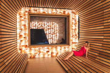 The girl visits the saline room for inhalation of the lungs and respiratory tract. Room from the Himalayan salt and dosing salt from the dead sea