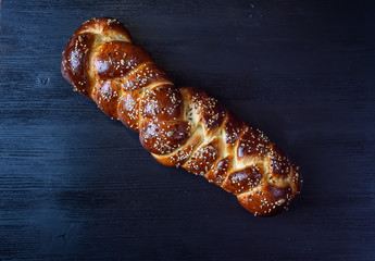 tasty challah on a wooden background