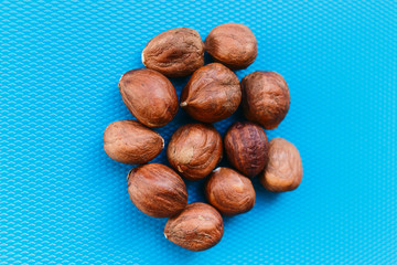 beautiful peeled hazelnuts on a blue background