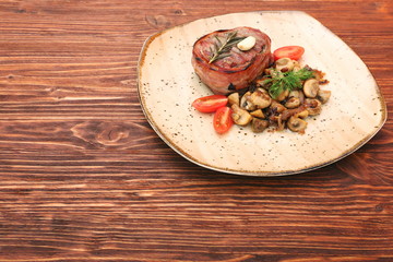 Tasty Beef steak with mushrooms and herbs on plate