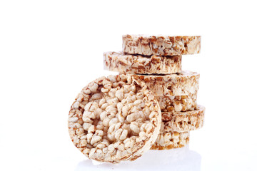 Round wheat crispbread, white background. Composition of crispbread on white background.