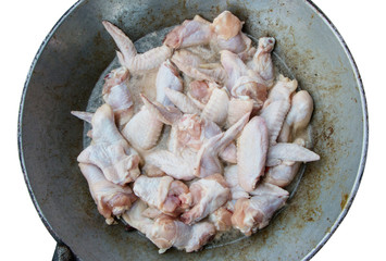 The wings and chicken broth are cooked in a hot pan