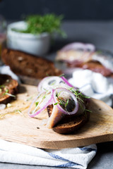 Open sandwich with herring with onion with rye bread, vertical, selective focus