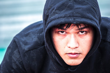Asian man preparing to run