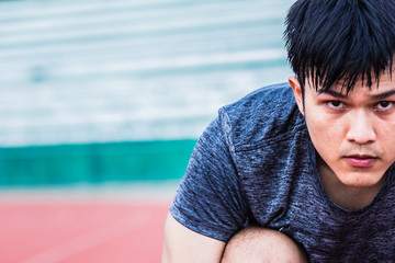 Asian man preparing to run