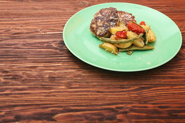 chicken cutlet, baked potatoes and vegetables