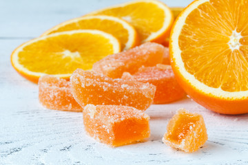 Fototapeta na wymiar Orange marmelad with slided oranges on table