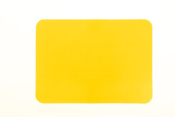 Yellow card isolated on white for sport concept