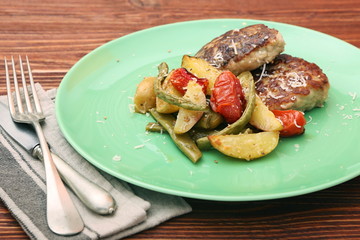 chicken cutlet, baked potatoes and vegetables