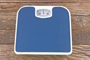 Weight bathroom scale on wooden floor