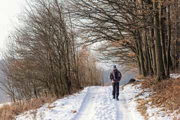 Fototapeta na wymiar Man walking on winter path