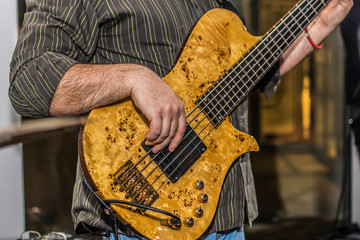Fototapeta premium Close-up photo of bass guitar player 