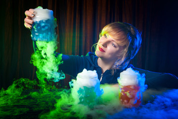 Dry ice in the water. Smoke from dry ice. The girl looks at the bark with dry ice.