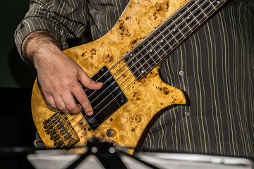 Close-up photo of bass guitar player 