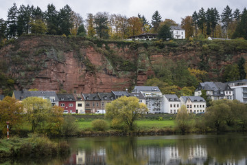 Fototapeta na wymiar Detail of Moselle river valley with typical village houses near Trier in rainy day in November, Germany. Dark autumn landscape.