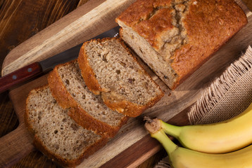 Overhead view of a loaf of sliced banana nut bread