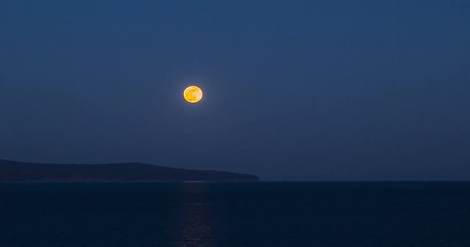 Full moon rising over the seashore