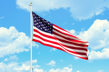 The flag of the USA wawing in the wind, hanged on a mast.