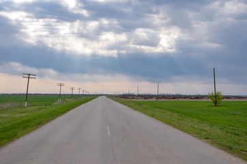 empty country road in grasslands under gorgeous clouds near Novyy Yegorlyk, Rostov region, Russia