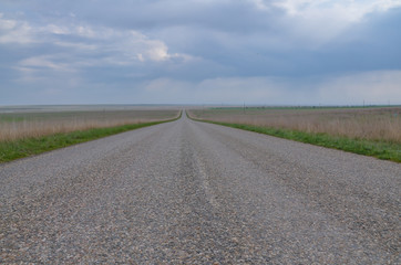 Fototapeta na wymiar empty straight road in steppe near salt lake Manych-Gudilo Yashalta, Republic of Kalmykia, Russia