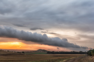Beautiful rural landscape with dramatic clouds in the sunset, Dobrogea, Romania