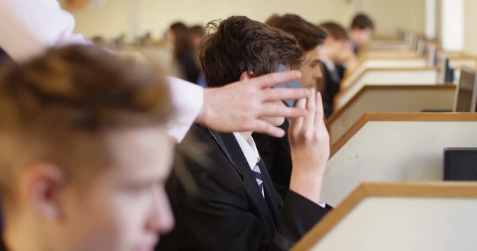 4k, Teacher catches student with a mobile phone during a lecture in a computer lab.