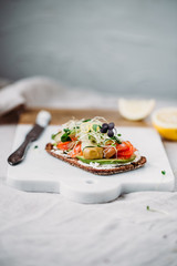 Smorrebrod - danish open sandwich with fish, herring, avocado