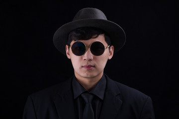 Obraz premium Portrait of a young Asian man. Close-up face on a black background