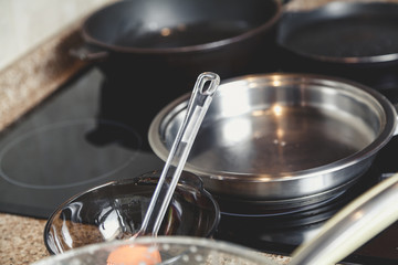 Three pans stand on electric stove