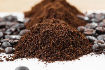 Coffee beans and powder on white background. grinding for espresso and alternative methods of brewing coffee
