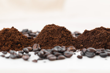 Coffee beans and powder on white background. grinding for espresso and alternative methods of brewing coffee