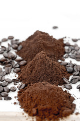 Coffee beans and powder on white background. grinding for espresso and alternative methods of brewing coffee