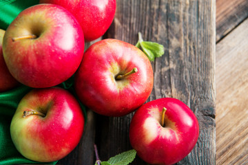 ripe red apples on wooden background
