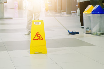 Sign showing warning of caution wet floor at airport.
