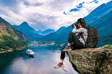 Geiranger fjord, Beautiful Nature Norway panorama. Nature photographer tourist with camera shoots. - obrazy, fototapety, plakaty