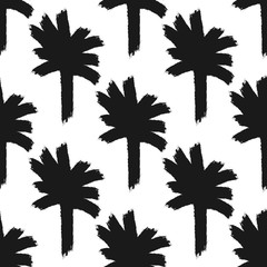 Fototapeta premium Repeating abstract silhouettes of palm trees drawn by hand with rough brush. Simple seamless pattern. Grunge, watercolour, graffiti, sketch, paint.