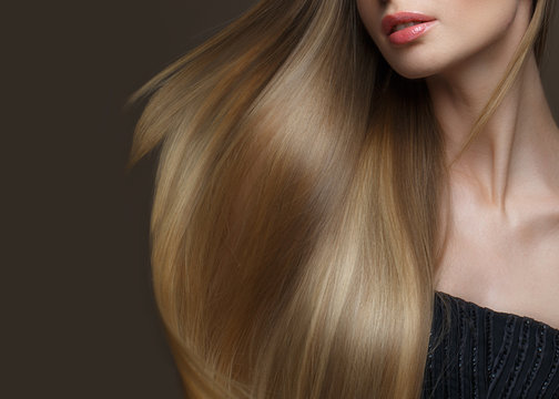 Fototapeta Beautiful blond girl with a perfectly smooth hair, classic make-up and red lips. Beauty face. Picture taken in the studio on a white background.