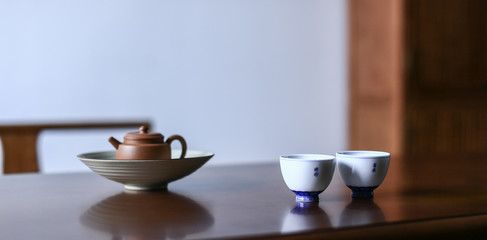 Fototapeta na wymiar Dark-red enameled pottery teapot