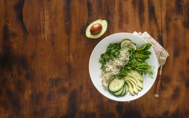 Detox salad on dark wooden background copy space, top view
