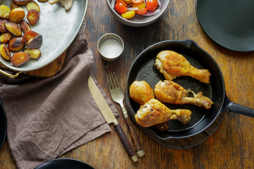 Fried chicken legs with potatoes and salad top view