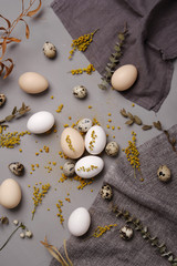 Eggs with flowers and decorative elements on concrete.
