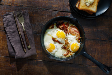Breakfast table concept. Fried eggs with bacon