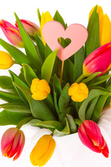 Obraz premium Bouquet of yellow and red fresh spring tulips isolated on white background