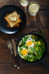 Fried eggs with vegetables. Breakfast table concept